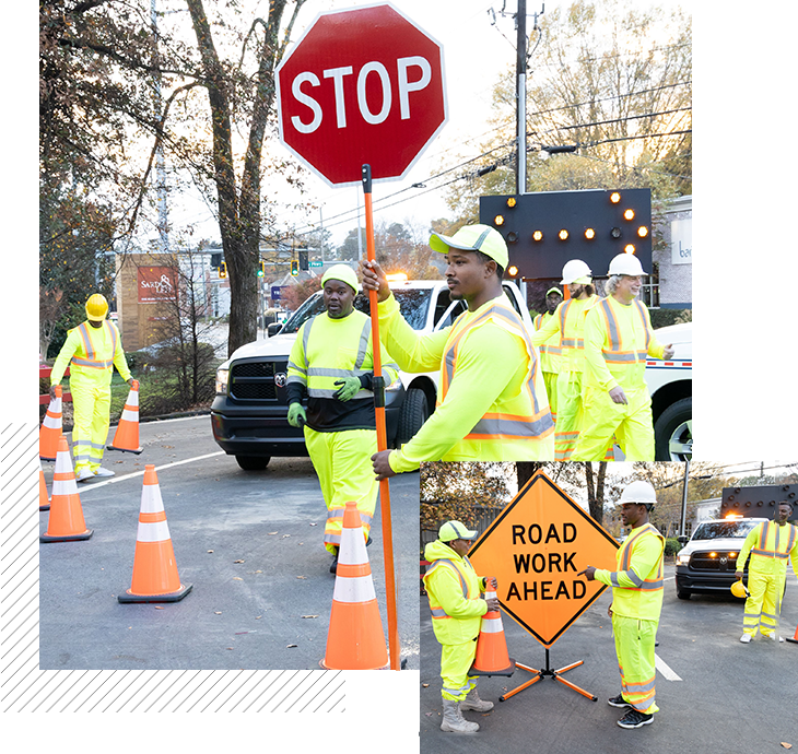 A group of construction workers standing around a stop sign.